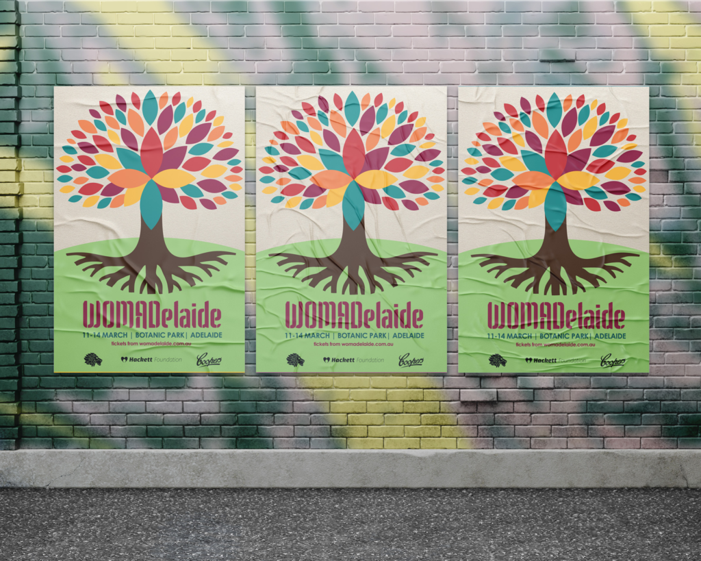 3 WOMAD posters on a brick wall.